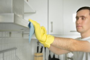 closeup-male-hands-rubber-gloves-cleaning-extractor-hood_1163-2424